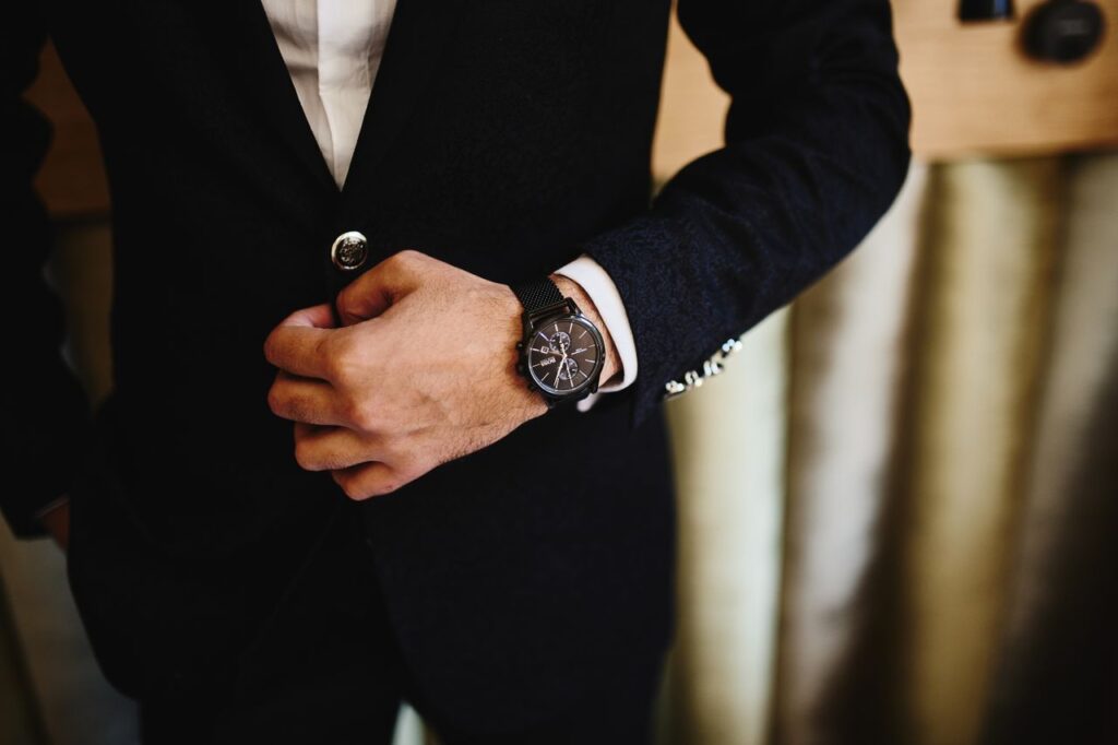 man in black suit wearing a watch